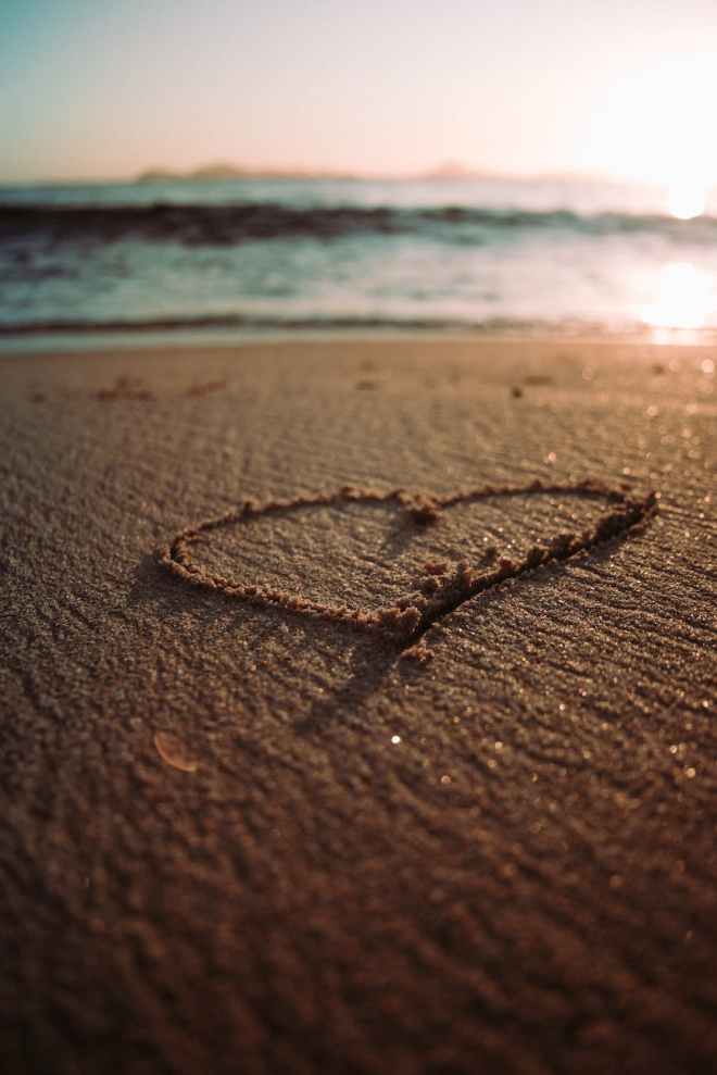 heart drawing on a sandy beach
